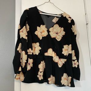 Black peplum blouse with cream flowers.